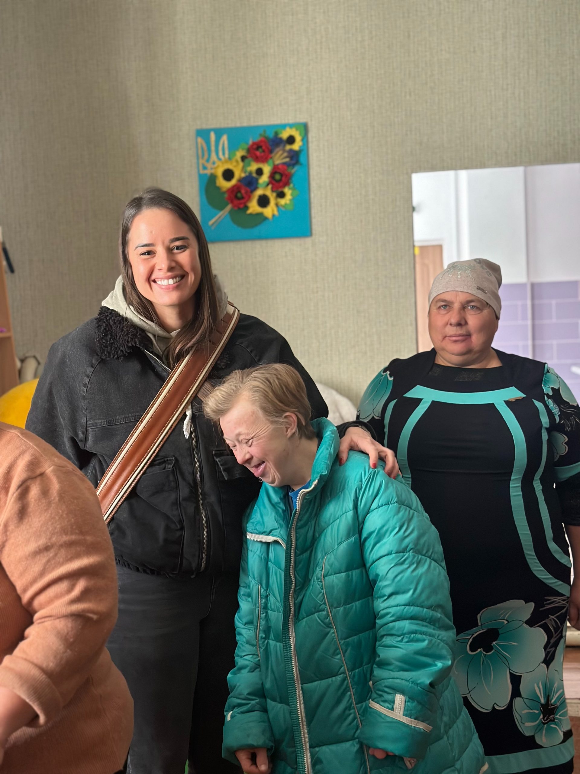 Redwood Global founders Samantha and Hope standing in a vehicle filled with home supplies.