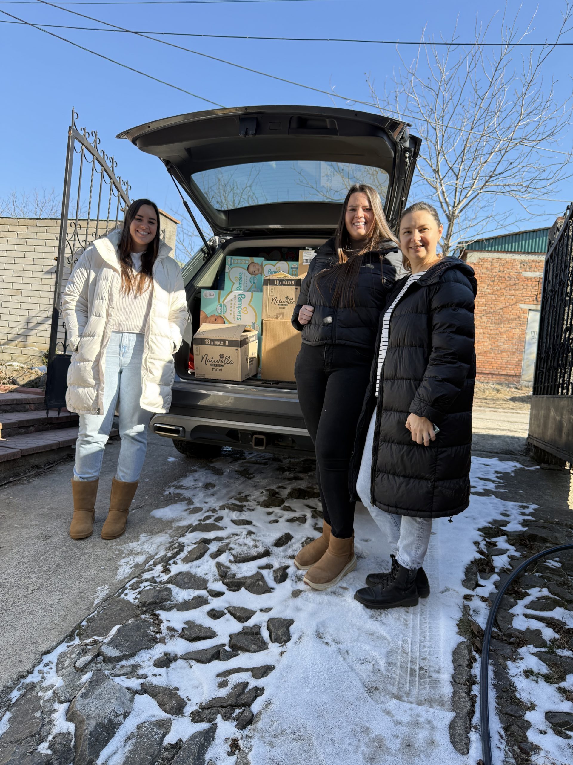 IMG_3378 Group of people watching 4 musicians performing in a large room with brick walls.