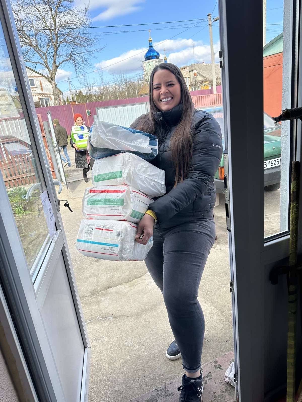 IMG_3498 Woman pushing two shopping carts of supplies.