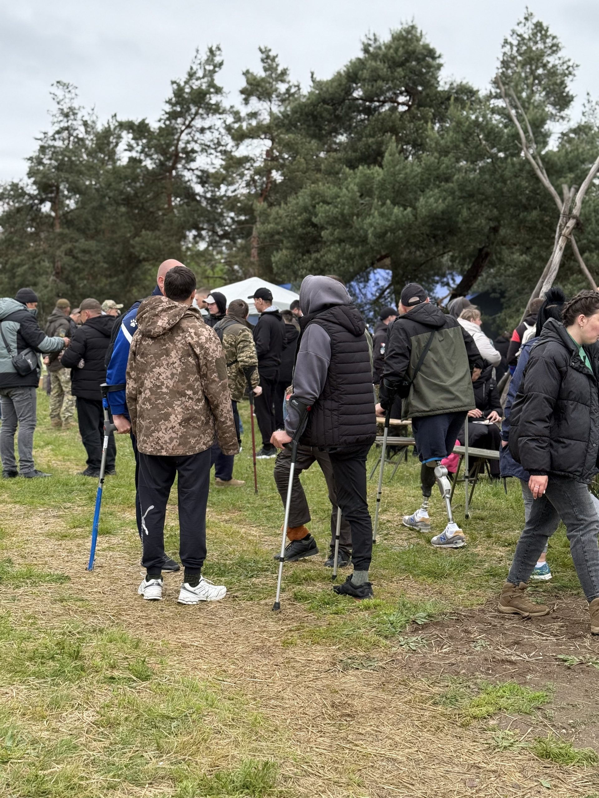 IMG_4624 Several people lending a hand to a woman in a wheel chair